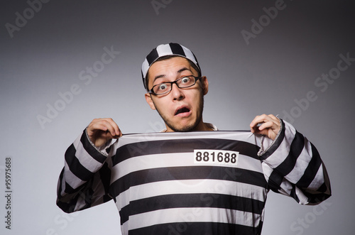 Young prisoner against gray photo