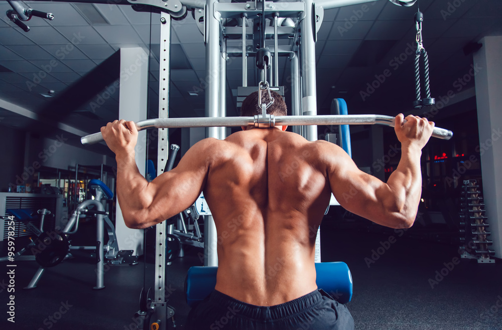 Very power athletic guy bodybuilder , execute exercise with simulator Very power athletic guy bodybuilder , execute exercise with simulator