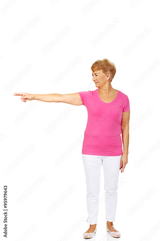 An old happy lady pointing for something An old happy lady pointing for something