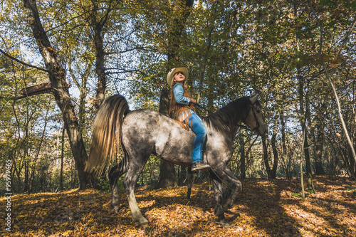 Pretty girl riding her grey horse © tinx