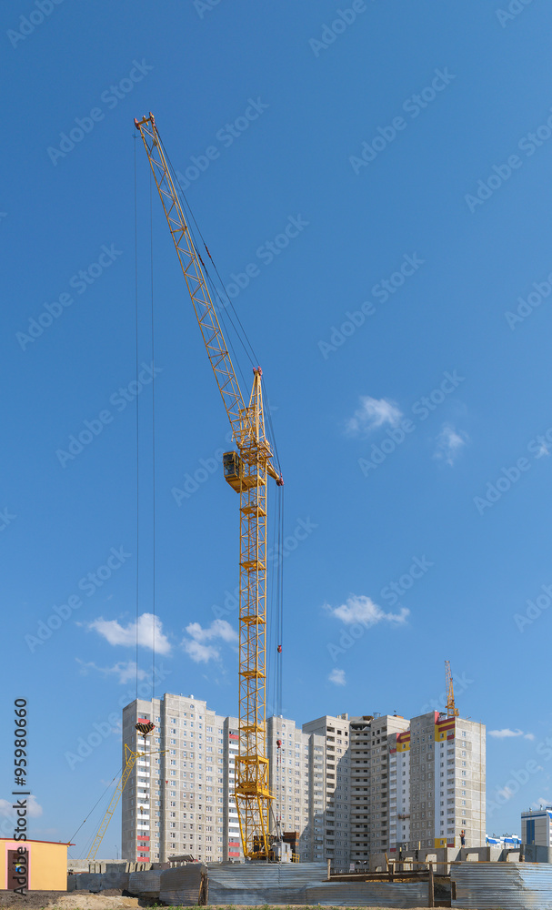 Tower crane on the construction of a new multi-storey house
