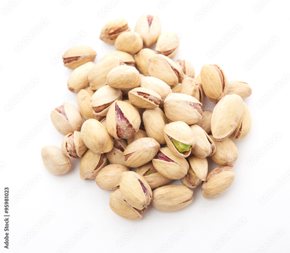 Heap of pistachios nuts isolated on the white Heap of pistachios nuts isolated on the white
