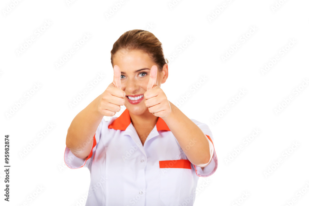 Young smile female doctor or nurse with thumbs up Young smile female doctor or nurse with thumbs up