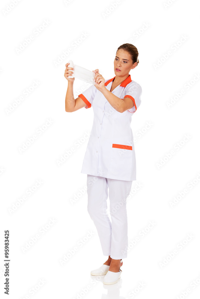 Young female nurse or doctor holding a bandage Young female nurse or doctor holding a bandage