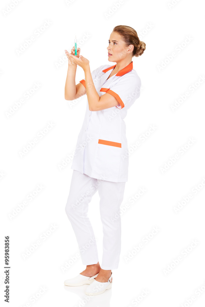 Female nurse or doctor with a syringe in hand Female nurse or doctor with a syringe in hand
