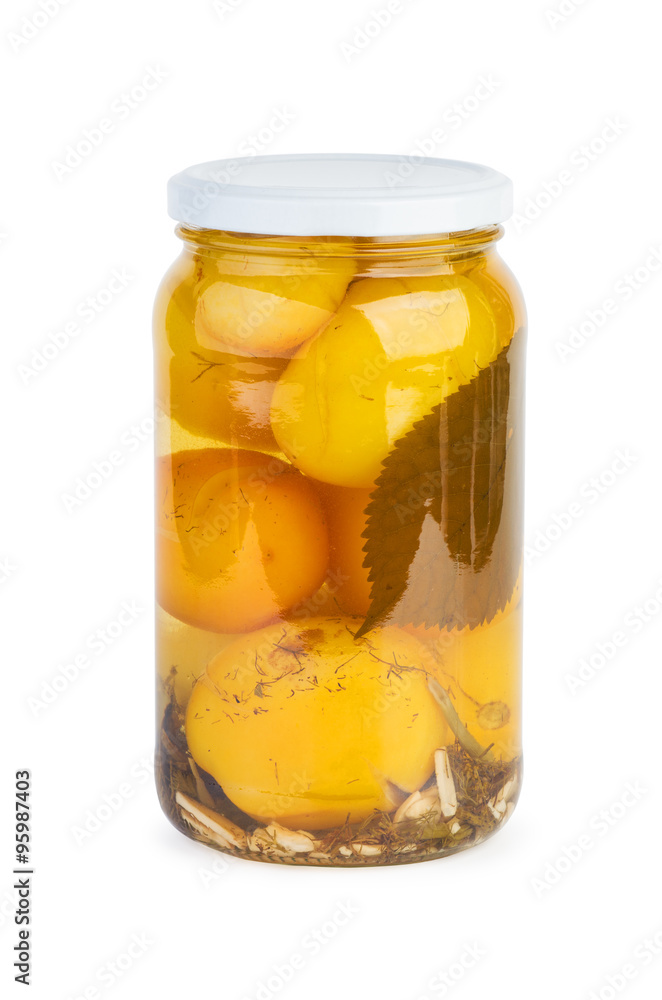 Glass jar with pickled yellow tomatoes Glass jar with pickled yellow tomatoes