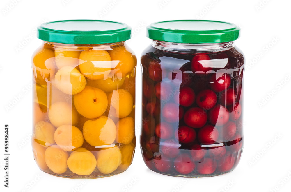 Glass jars with preserved cherries and apricots
