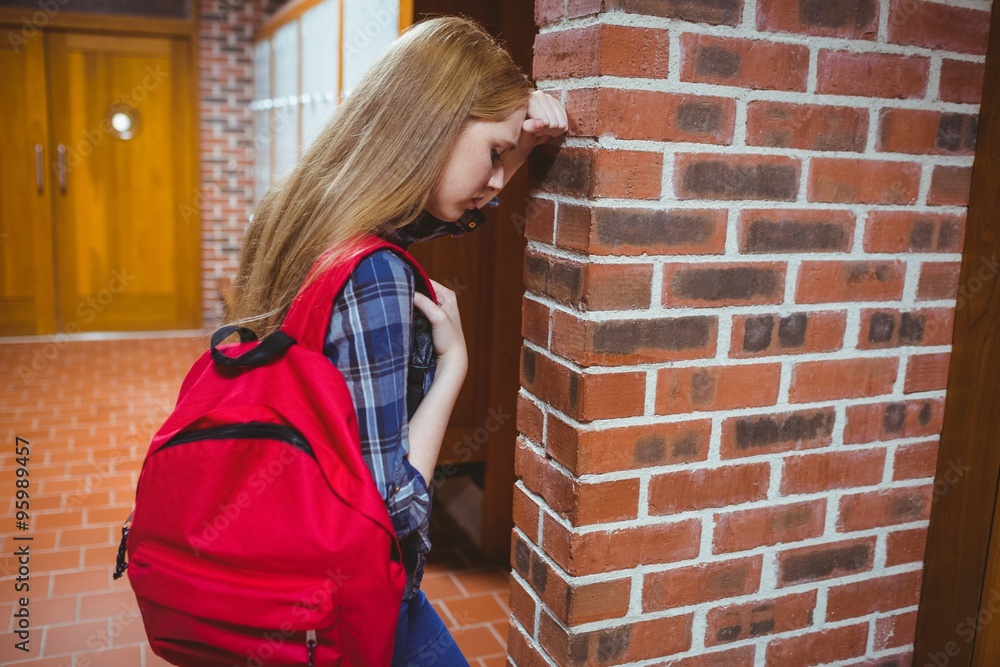 Worried student leaning against the wall Worried student leaning against the wall