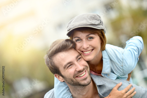 Portrait of man giving piggyback ride to girlfriend