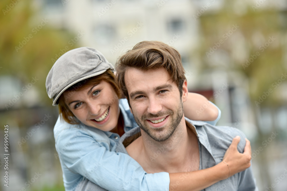 Portrait of man giving piggyback ride to girlfriend Portrait of man giving piggyback ride to girlfriend