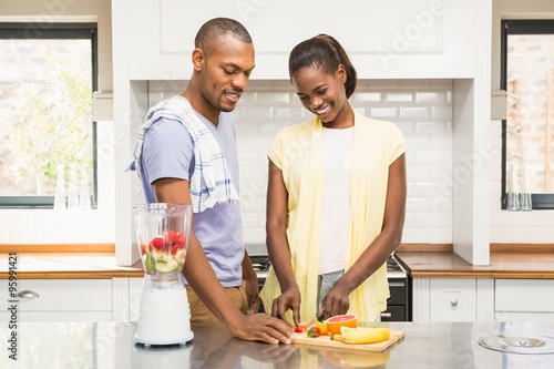 Young casual couple making fruits 