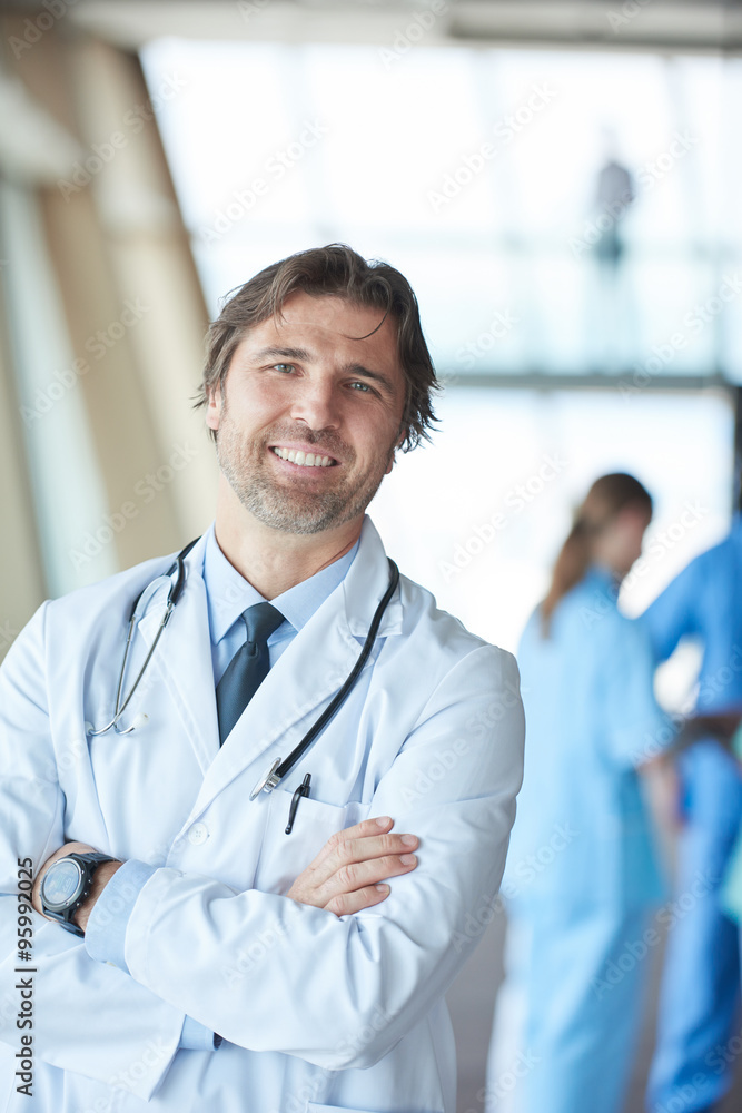 group of medical staff at hospital, handsome doctor in front of group of medical staff at hospital, handsome doctor in front of