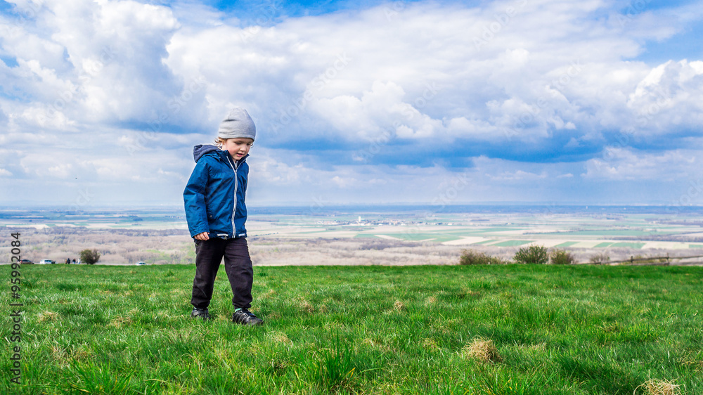 young handsome boy walking on green grass young handsome boy walking on green grass