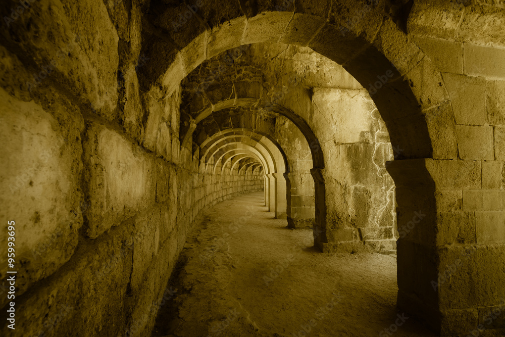 Internal passages in the ancient Roman amphitheater of Aspendos. The province of Antalya. Mediterranean coast of Turkey. Vintage toning. Stylization.