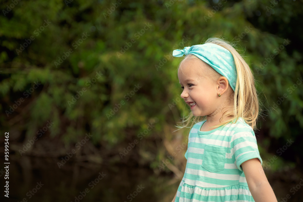 Adorable blond girl laughing, having fun outdoors Adorable blond girl laughing, having fun outdoors