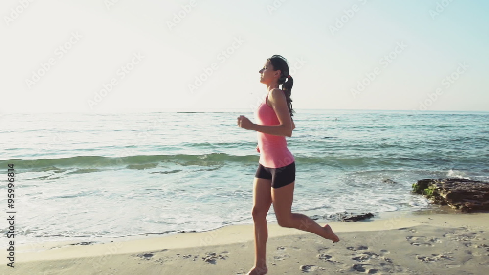 young female does jogging on the beach slow motion young female does jogging on the beach slow motion