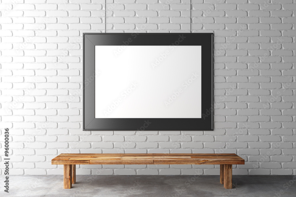 Blank picture frame on brick wall with wooden bench on concrete Blank picture frame on brick wall with wooden bench on concrete