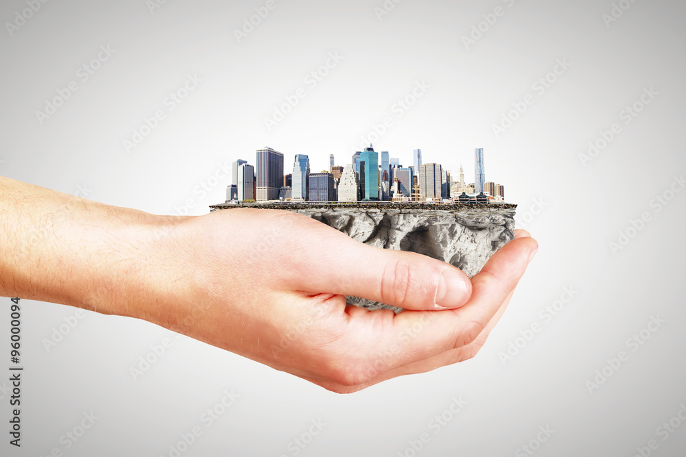 Whole world in one hand concept with man hand and part of megapo Whole world in one hand concept with man hand and part of megapo