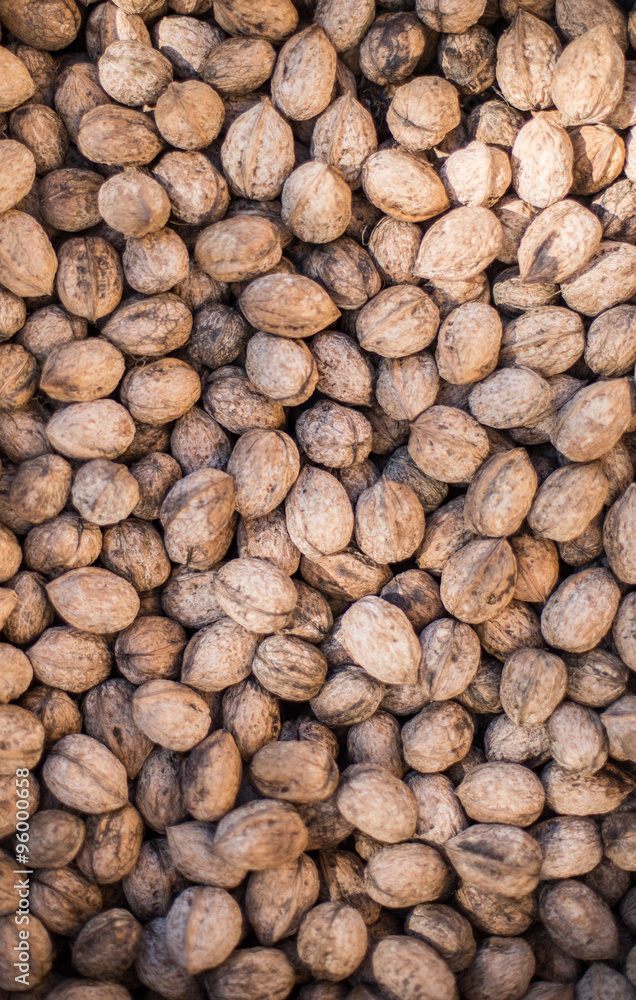 Walnut background, scattered pile of walnuts Walnut background, scattered pile of walnuts
