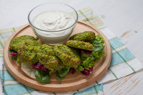 Falafel and sour cream, wood background