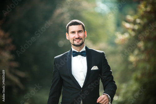 confident groom posing
