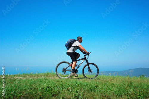 Cyclist rides a bicycle © unclepodger