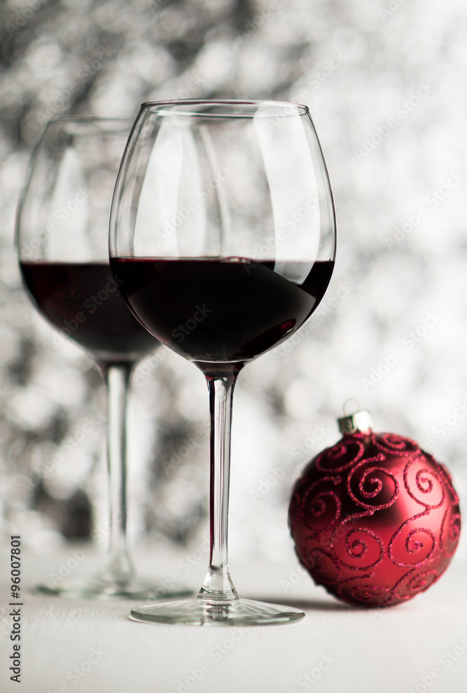 Wine and christmas ball on bright background Wine and christmas ball on bright background