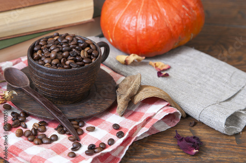 Fototapeta Naklejka Na Ścianę i Meble -  Wooden cup with coffee and grinder on the autumn background