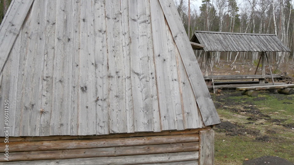 The big triangular hut inside the forest. The wooden hut with lots of trees in the area in the forest The big triangular hut inside the forest. The wooden hut with lots of trees in the area in the forest