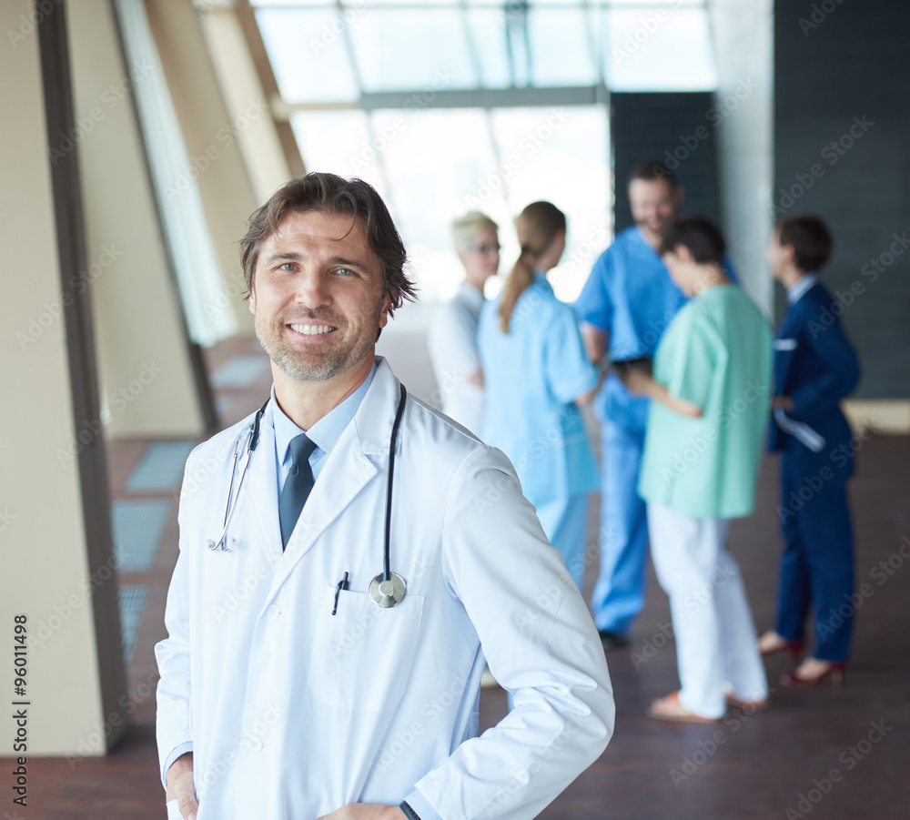 group of medical staff at hospital, handsome doctor in front of group of medical staff at hospital, handsome doctor in front of
