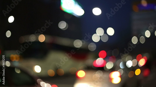   city lights in a blurred, bokeh and out of focus context with traffic in evening time  photo