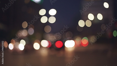   city lights in a blurred, bokeh and out of focus context with traffic in evening time  photo