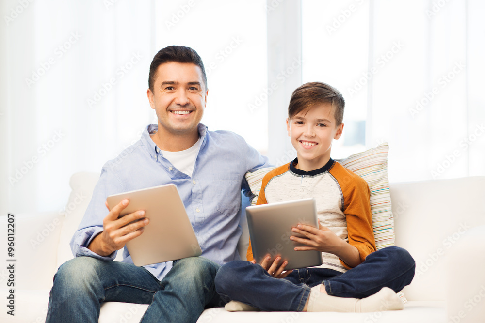 happy father and son with tablet pc at home happy father and son with tablet pc at home