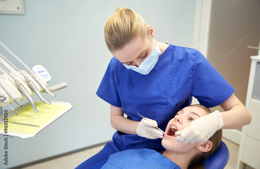 female dentist checking patient girl teeth female dentist checking patient girl teeth