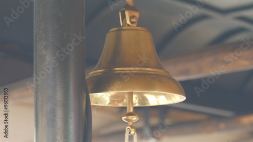 Wallpaper Mural Golden small bell hanging on the roof. The bell is located on the roof of a building  Torontodigital.ca