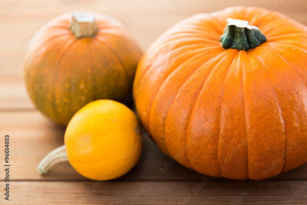 close up of pumpkins on wooden table at home close up of pumpkins on wooden table at home