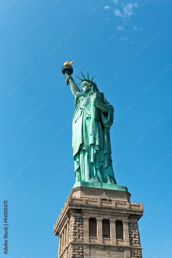 Fototapeta premium Statue of Liberty Against Blue Sky in Manhattan