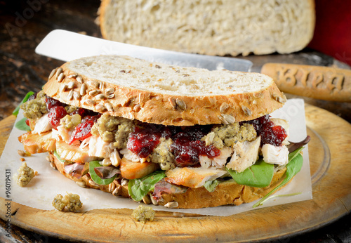 Turkey, chicken sandwich with stuffing and cranberry sauce.