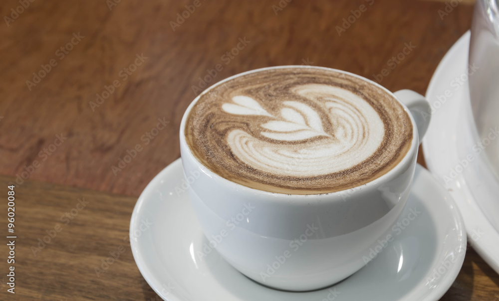 Close up white cup of Coffee, latte on the wooden table Close up white cup of Coffee, latte on the wooden table