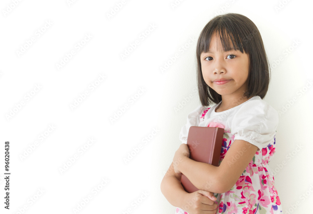 Lovely little girl holding a notebook on white background Lovely little girl holding a notebook on white background