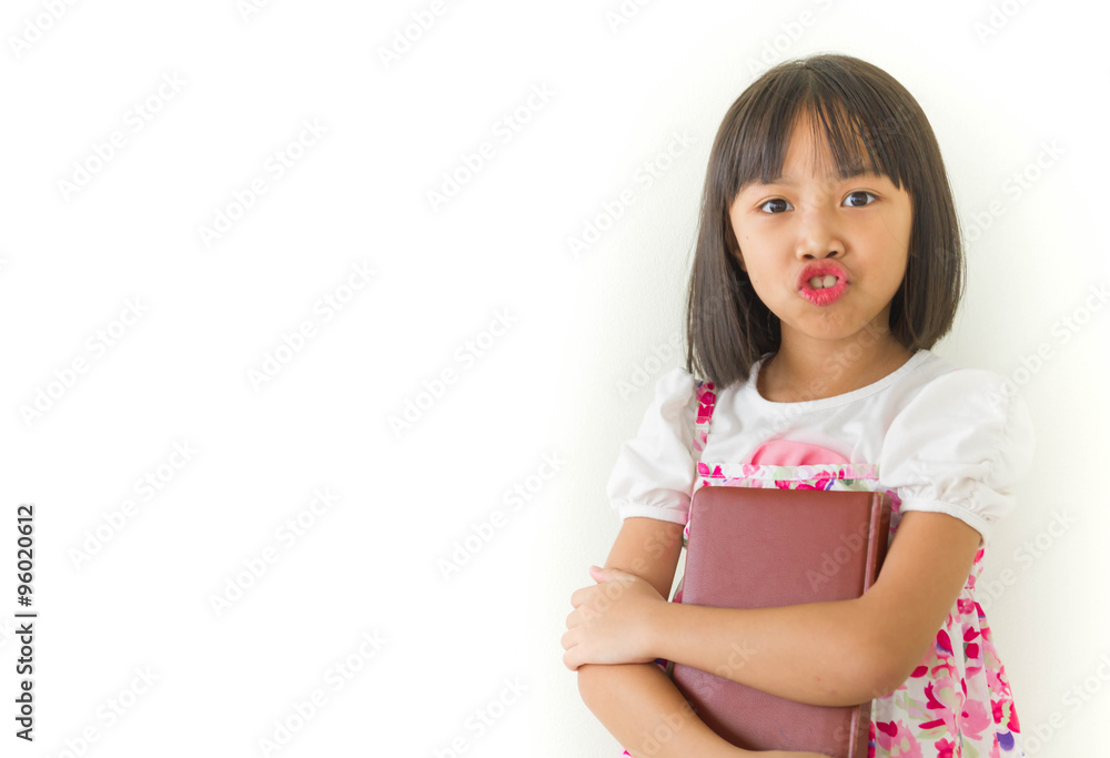 Lovely little girl holding a notebook on white background Lovely little girl holding a notebook on white background