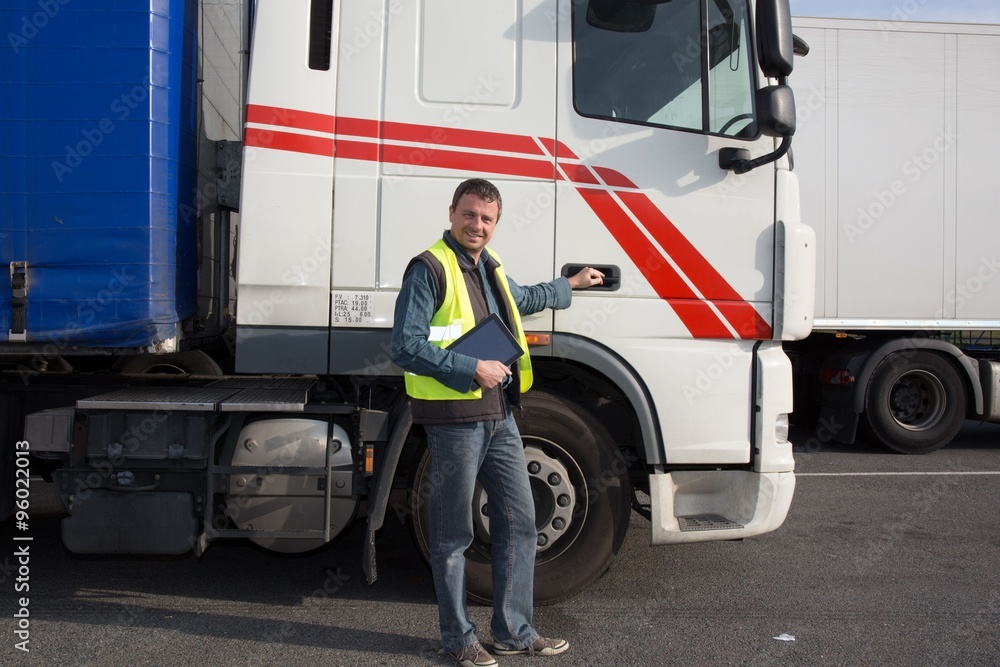 Logistics - proud driver with tablet computer, in front of trucks . Logistics - proud driver with tablet computer, in front of trucks .
