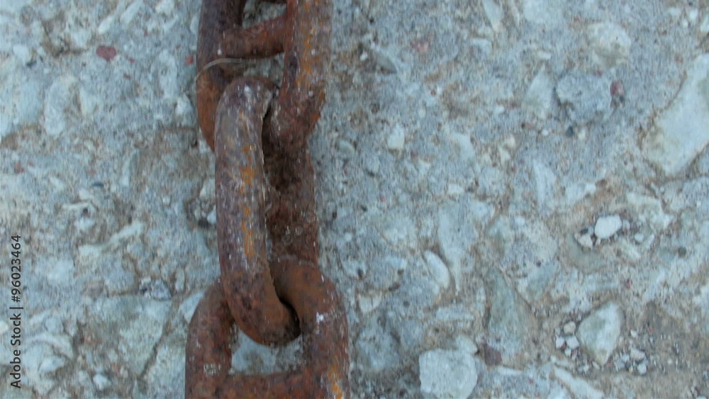 Red big chain on the white rock ground. The chain is connected maybe on an anchor of a big boat Red big chain on the white rock ground. The chain is connected maybe on an anchor of a big boat