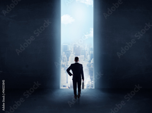 businessman in front of the huge gate