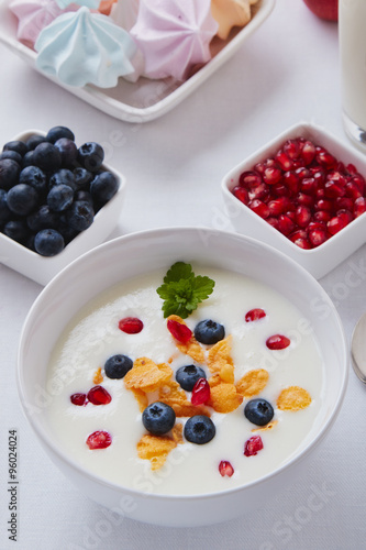 yogurt with cereals, blueberry and pomegranate