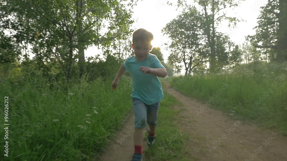 Happy child running in the woods at sunset Happy child running in the woods at sunset