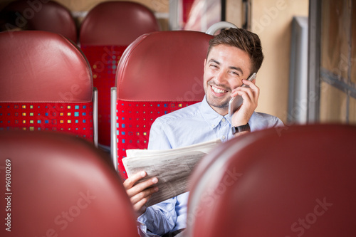 Businessman with phone and newspaper