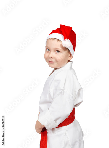Little boy in a kimono with a red belt and cap of santa claus