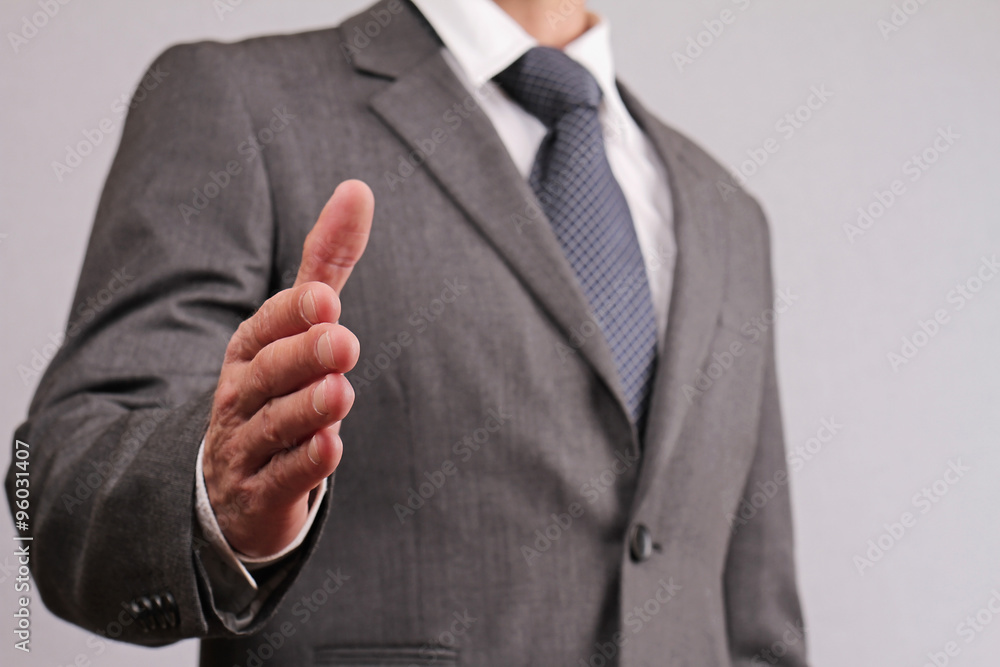Close up of businessman with open hand ready to seal a deal gesturing a hand shake. Meeting new business partners, partnership, negotiations, presentation Close up of businessman with open hand ready to seal a deal gesturing a hand shake. Meeting new business partners, partnership, negotiations, presentation