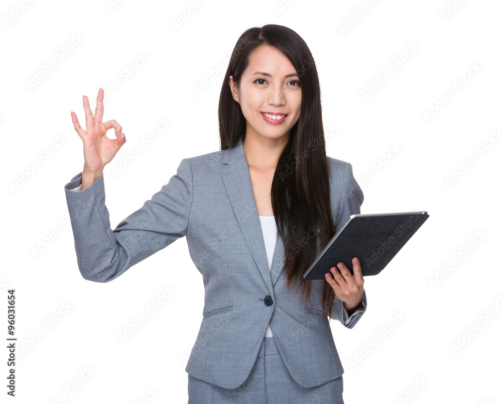 Asian Young Businesswoman hold with tablet and ok sign gesture Asian Young Businesswoman hold with tablet and ok sign gesture